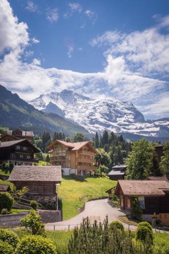 a village with a snow covered mountain in the background at Chalet Fortuna 4 Penthouse in Wengen