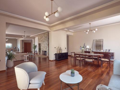 an open living room with a table and chairs at Serenus Luxury Villa in Keri