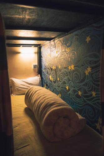 a bed in a room with a wall with stars at Wander Thirst in Kathmandu