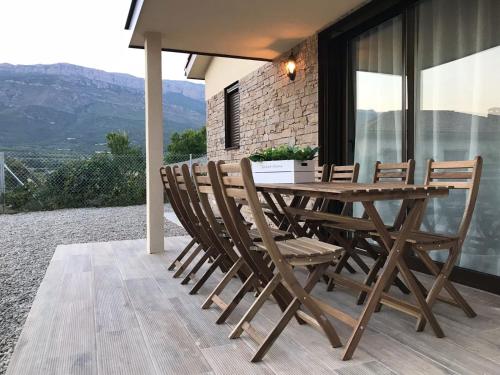 a wooden table and chairs on a patio at La Caseta d'Àger in Ager