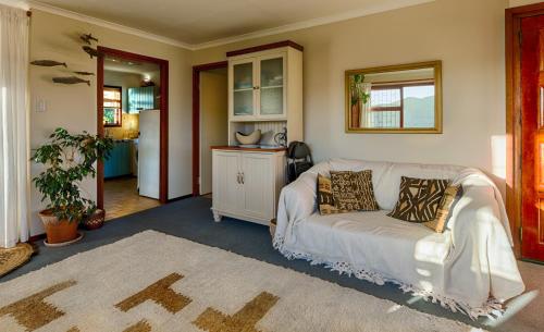 a living room with a white couch in a room at Bay Vista Garden Flat in Glencairn