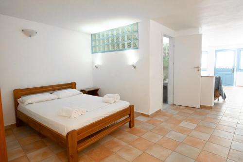 a bedroom with a bed with towels on it at Afroditi Pansion in Agios Nikitas