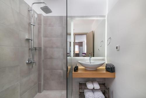 a bathroom with a sink and a shower at Maridenia Villa in Lithakia