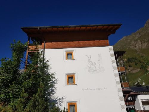 a building with a drawing on the side of it at Apart-Garni Motnaida in Samnaun