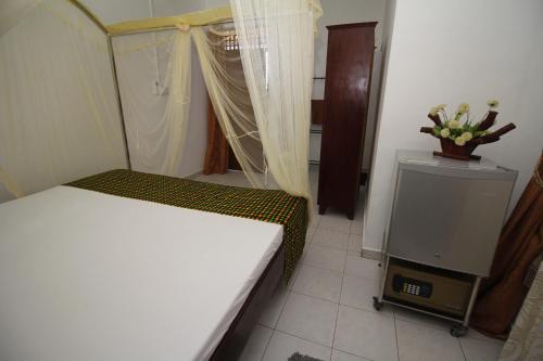 a bedroom with a bed and a tv in a room at Bentota Home Stay in Bentota