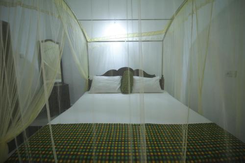 a bed in a room with a glass wall at Bentota Home Stay in Bentota