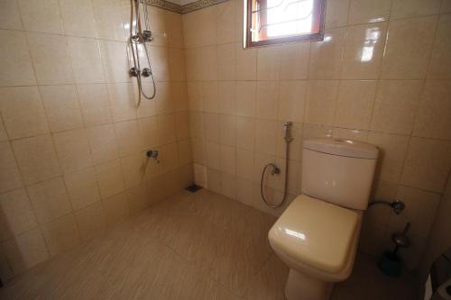 a bathroom with a toilet and a shower at Bentota Home Stay in Bentota