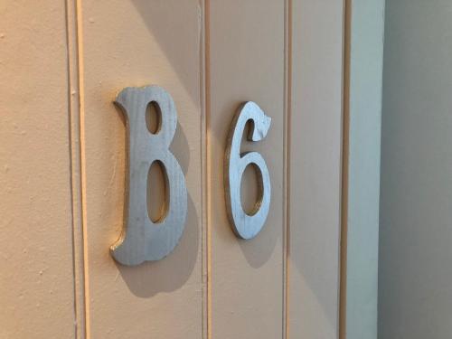 a house number hanging on a door at DDay Aviators Le Manoir in Arromanches-les-Bains