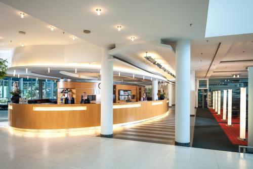 a lobby of an office building with a reception counter at Dorint Hotel Potsdam in Potsdam