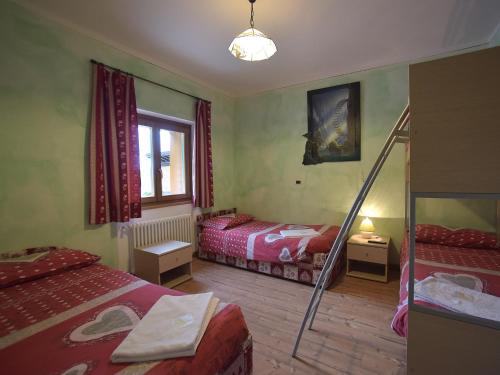 a room with two beds and a staircase in it at Rifugio Fedaia in Malga Ciapela