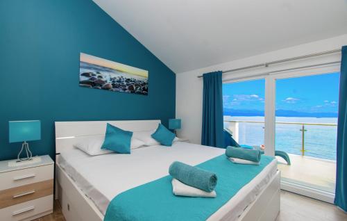 a bedroom with a bed with a view of the ocean at Corcyra Nigra Apartment in Blato
