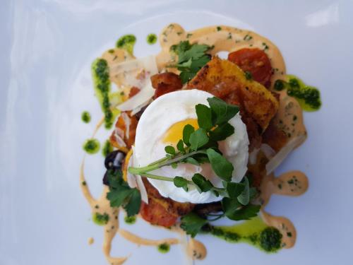 a plate of food with an egg on top at The Bay in Rivière Noire