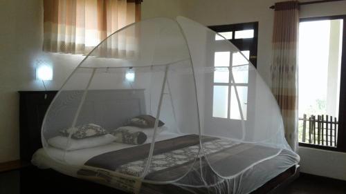 a bed with a canopy in a room at Ella Repose in Ella