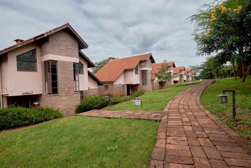 a row of houses on a brick road at Sagana Getaway Resort in Maranjua