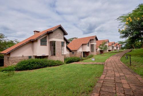 a row of houses with a brick road at Sagana Getaway Resort in Maranjua