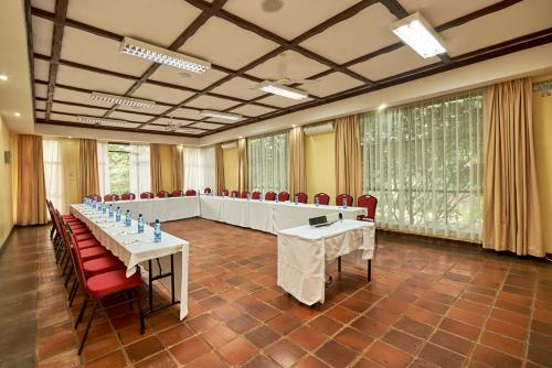 a large meeting room with tables and chairs in it at Sagana Getaway Resort in Maranjua