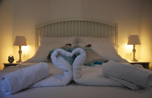 a bed with white towels in the shape of a heart at Levantara in Jezera