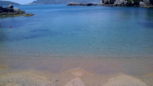 a large body of water with rocks in it at Hotel Fiascherino in Lerici