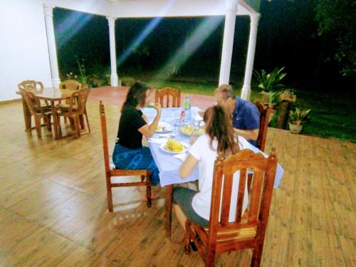 a group of people sitting at a table at Siyapath Holiday Resort in Polonnaruwa