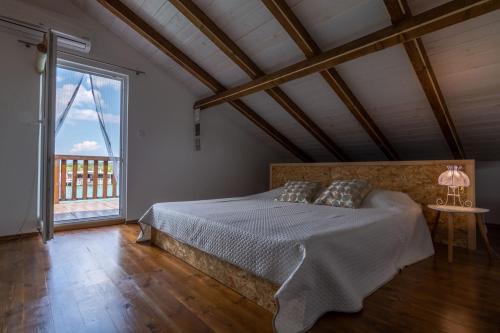 a bedroom with a bed and a large window at Hakuna Matata Apartments in Ulcinj