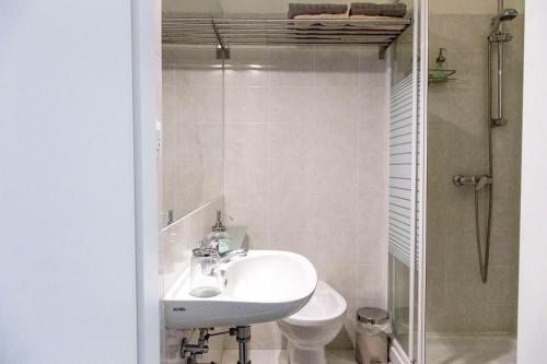 a bathroom with a sink and a toilet and a shower at b&b al parco in Trieste