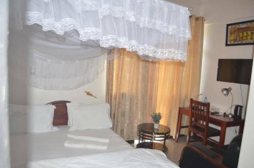 A bed or beds in a room at Cashewnut Hotel