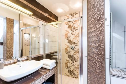 a bathroom with a sink and a shower at Pillow House Tatras in Stará Lesná