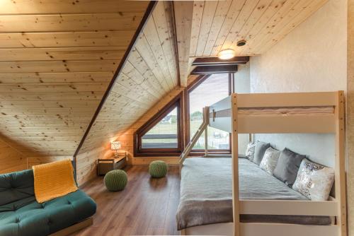 a room with a bunk bed and a couch at Pillow House Tatras in Stará Lesná
