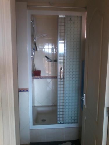 a bathroom with a shower with a glass door at Chez Cozy's in Albion