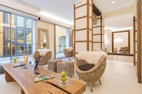 a living room with a wooden table and chairs at Hotel Metropolitan in Bologna