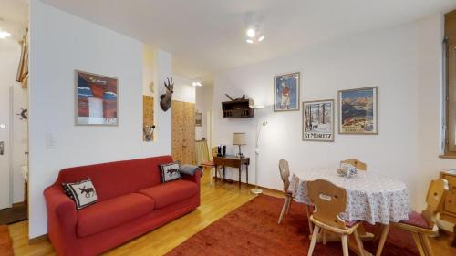 サンモリッツにあるHaus Westend 1の赤いソファとテーブルのあるリビングルーム
