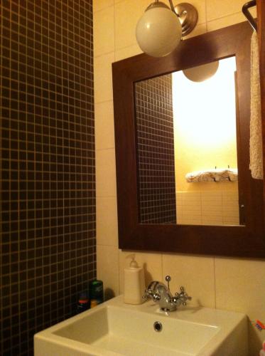 a bathroom with a sink and a mirror at Vila Škrlec in Baška Voda