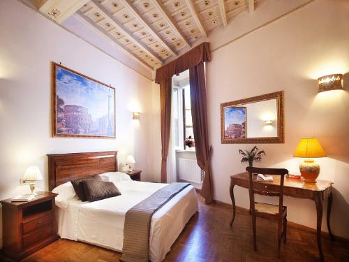 a bedroom with a bed and a table and a desk at Pantheon Inn in Rome
