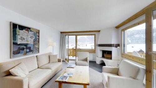 a living room with a couch and a table at Albana 212/215 in Silvaplana