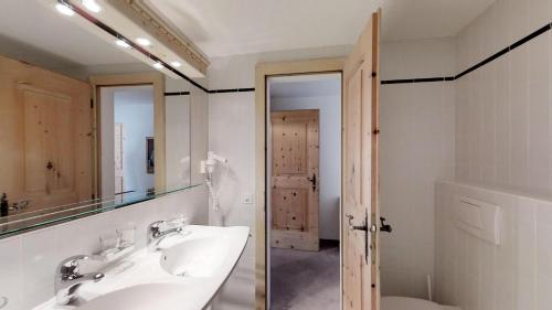 a bathroom with a sink and a mirror at Albana 212/215 in Silvaplana