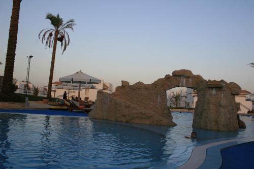 a pool with a water slide in a resort at Rivera Sharm Habiba Apartments in Sharm El Sheikh