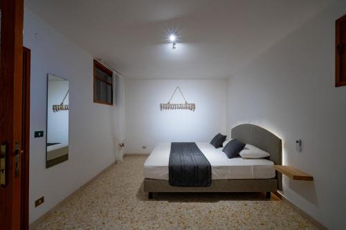 a bedroom with a bed in a white room at Borgo Canneto in Rodi Garganico