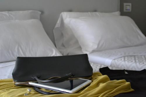 a bed with two laptop computers on top of it at Hotel Panorama in Chianciano Terme