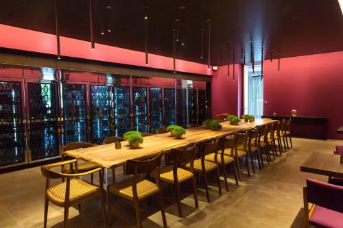 a long dining room with a long table and chairs at Domotel Kastri in Athens