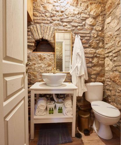a bathroom with a sink and a toilet at Athenian Residences in Athens