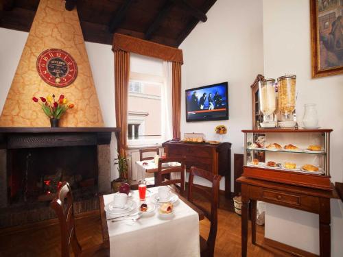 a living room with a table and a fireplace at Pantheon Inn in Rome