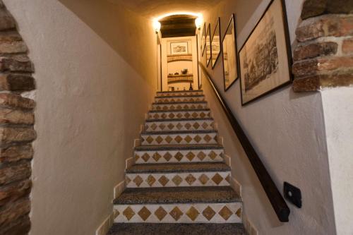 a staircase in a house with a tile stair case at B&B La Dolce Vita in Priocca