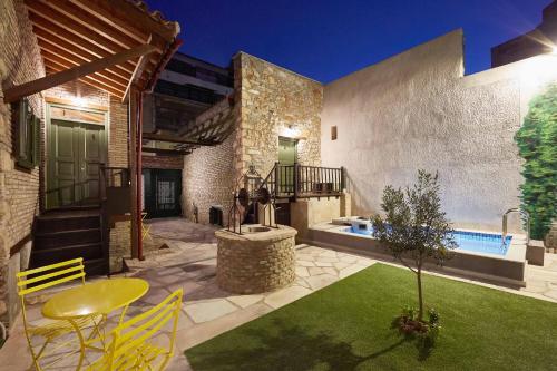 a backyard with a pool and a table and chairs at Athenian Residences in Athens