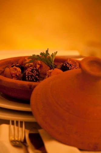 a bowl of food sitting on top of a table at Riad Dar Maya in Essaouira