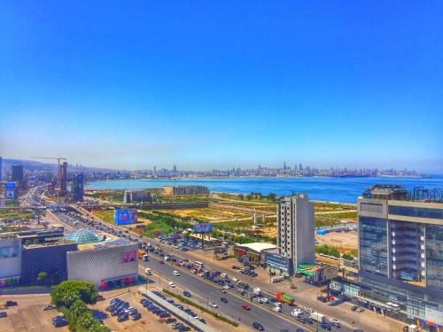 an aerial view of a city with a river and buildings at Louis V Hotel Beirut in Beirut