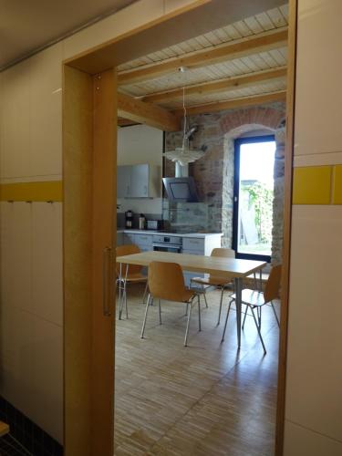 a kitchen and dining room with a table and chairs at Alte Scheune Rietzschelhof in Müglitztal