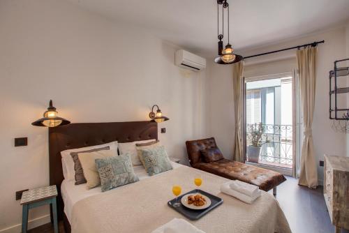 a bedroom with a bed with a tray of food on it at Fee4Me Marques Vintage Apartment in Madrid