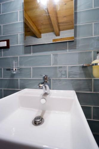 a bathroom with a white sink and a mirror at Kyriaki's Traditional Loft in Galatás