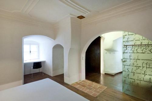 a room with a wall with writing on the wall at Turmhotel in Enns