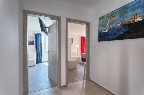 a hallway with a mirror and a painting on the wall at Luxury flats in city centre in Pula
